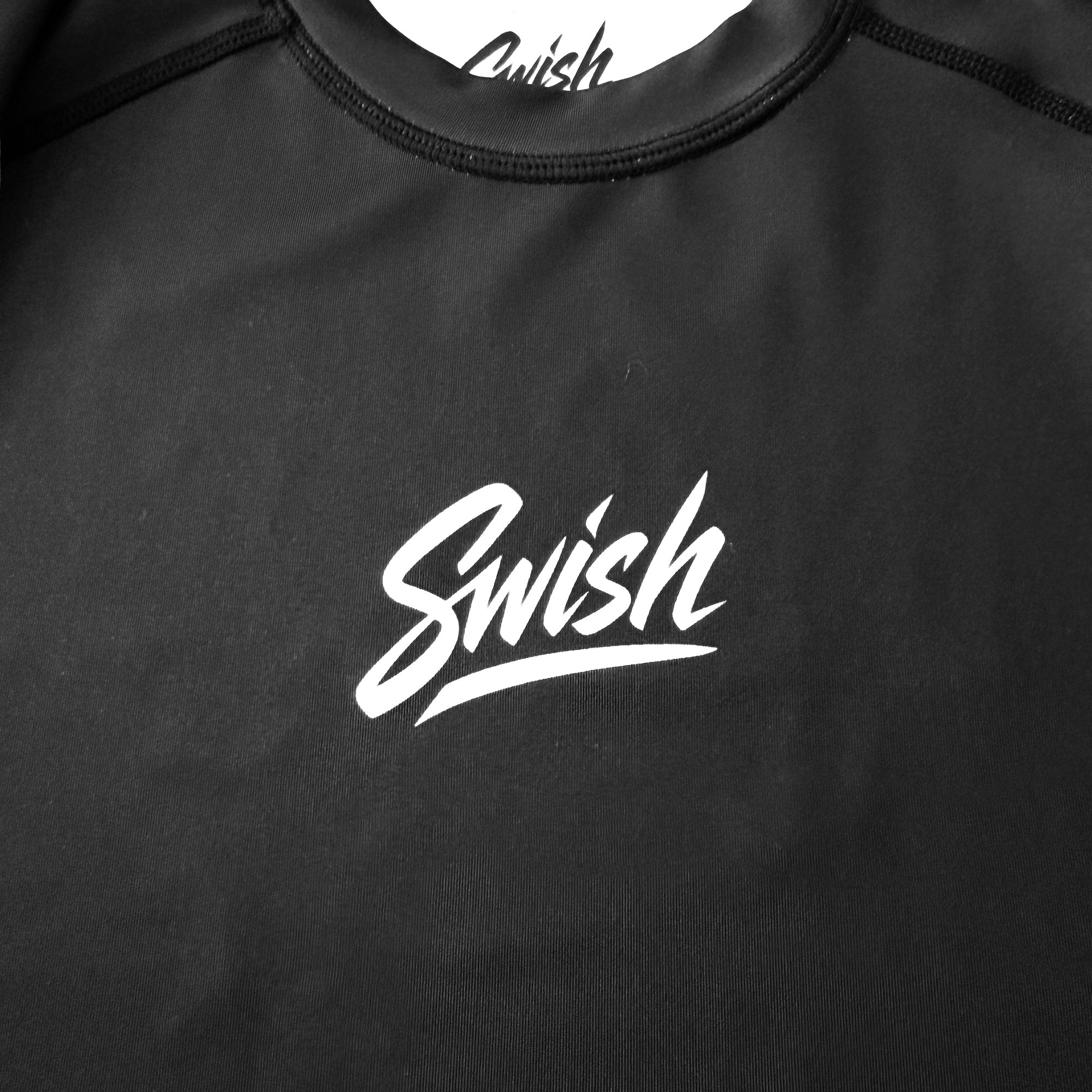Black shirt with 'Swish' logo on a dark background